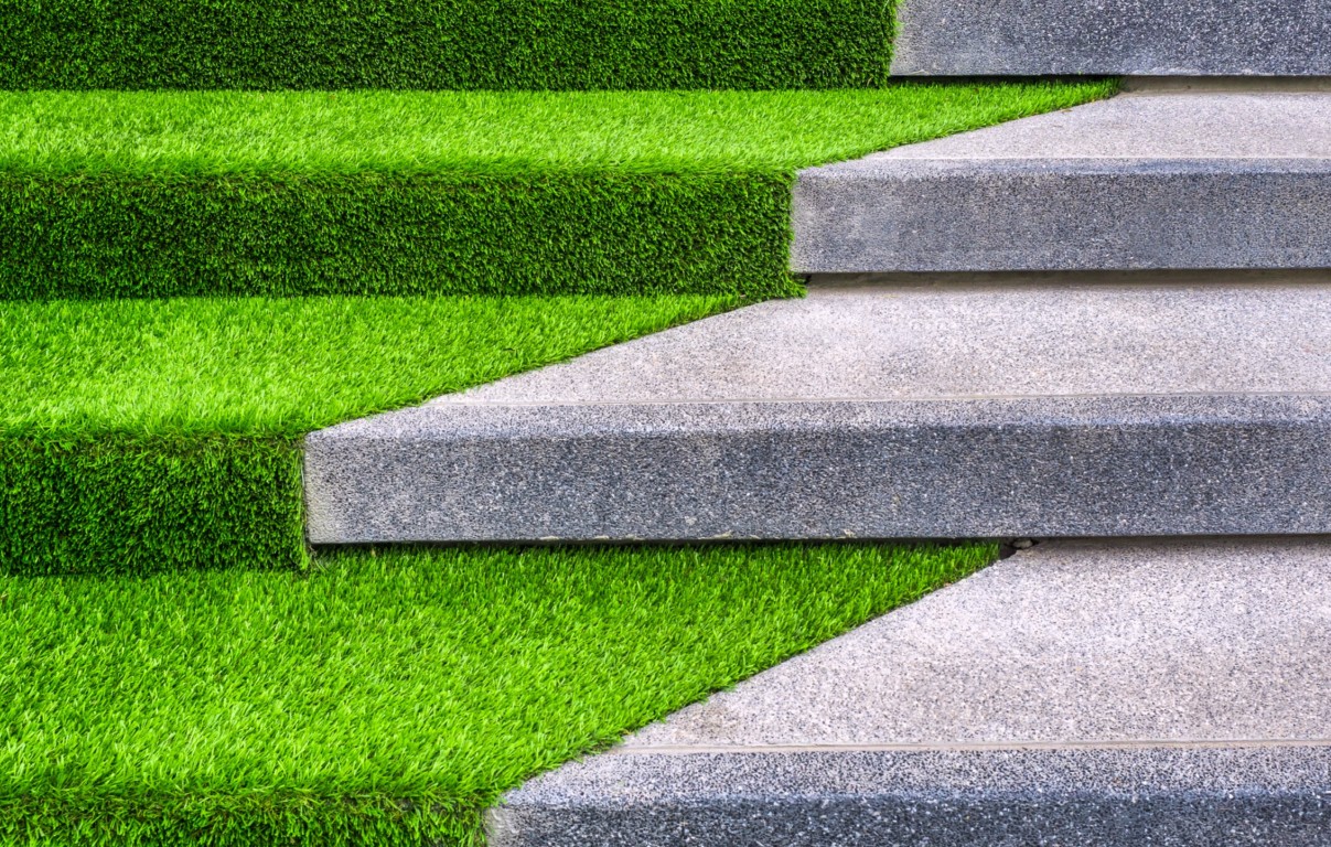 Safe playground turf installation alongside stone steps
